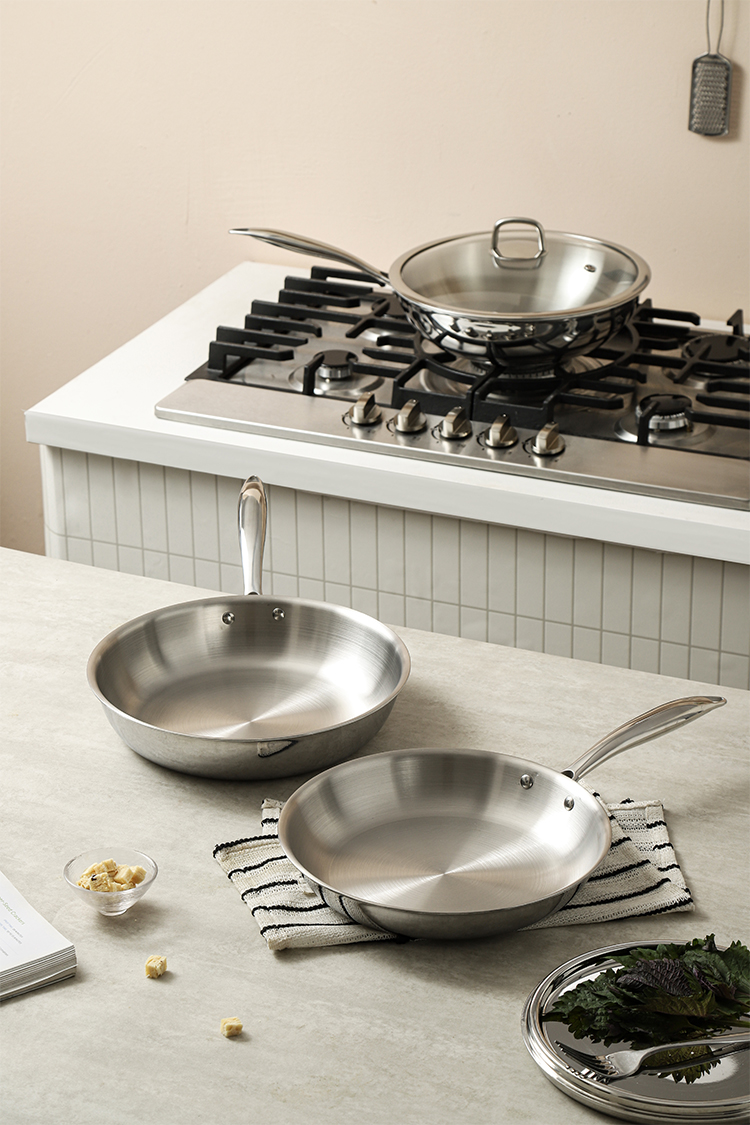 Tri-ply stainless steel frying pan in a kitchen setting